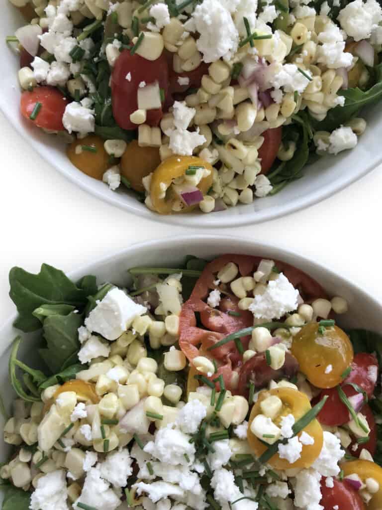 Tomato and Corn Salad with red onion, feta, arugula and chives